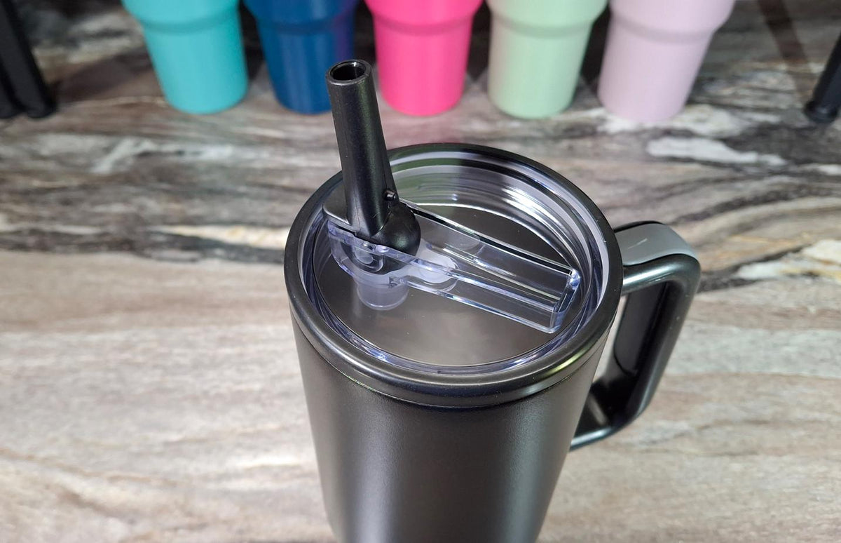 Black 40 oz tumbler with the straw in its flip lid