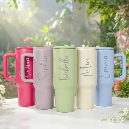 Five custom engraved 40 oz tumblers with handles in Hot Pink, Purple, Light Green, Cream and Light Blue, each engraved with a name