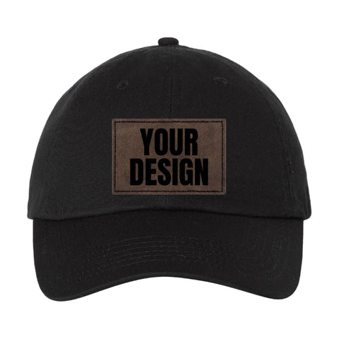 Custom low profile patch hat, black unstructured Valucap VC300A dad hat with a laser-etched brown patch reading Design Yours