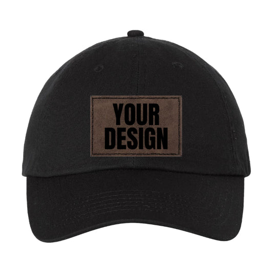 Custom low profile patch hat, black unstructured Valucap VC300A dad hat with a laser-etched brown patch reading Design Yours