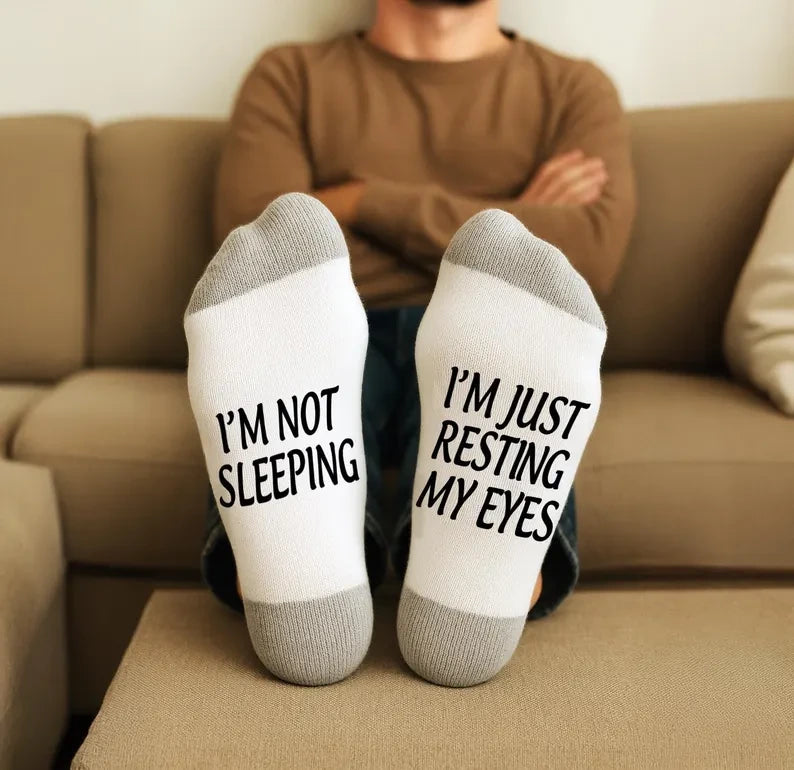 Custom printed socks, white with gray heel and toe, soles printed I'M NOT SLEEPING and I'M JUST RESTING MY EYES