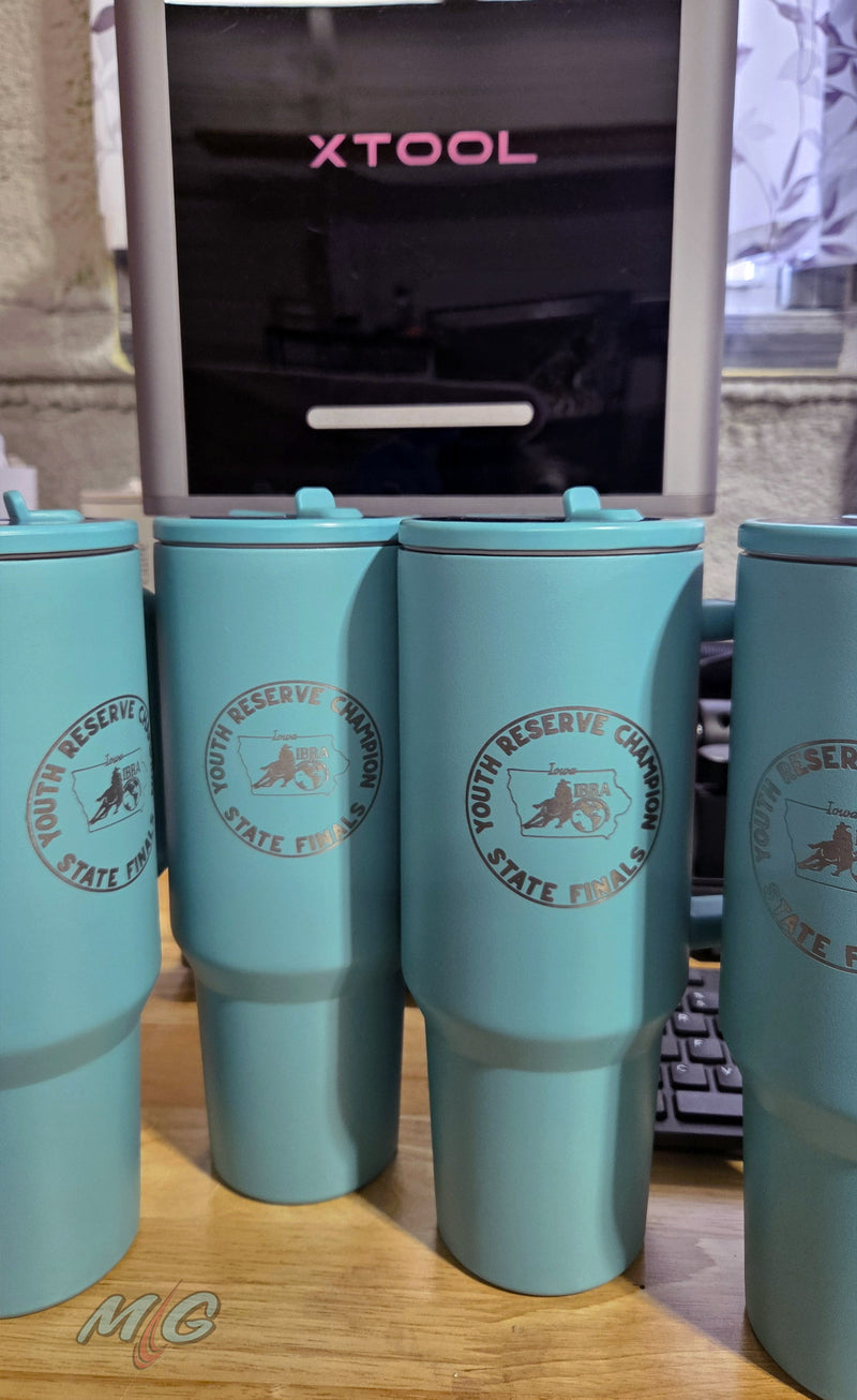 Teal 40 oz tumblers laser engraved with the NBHA Iowa Youth Reserve Champion State Finals award seal