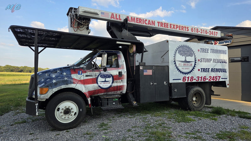 All American Tree Experts bucket truck with an American flag cab wrap and lettered service body by Martin Graphics